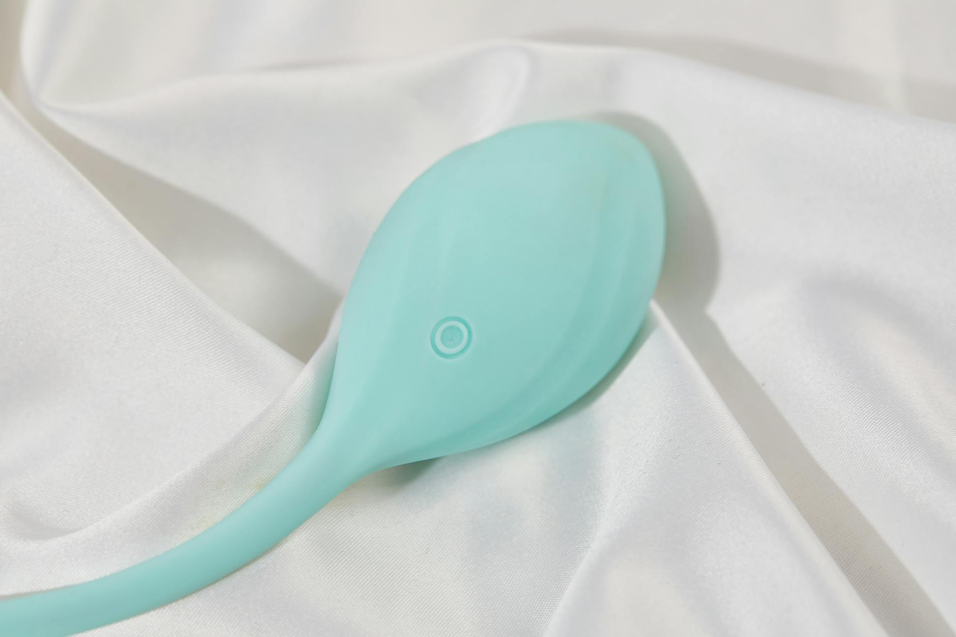 Woman holding a contemplative pose with a vibrator in hand