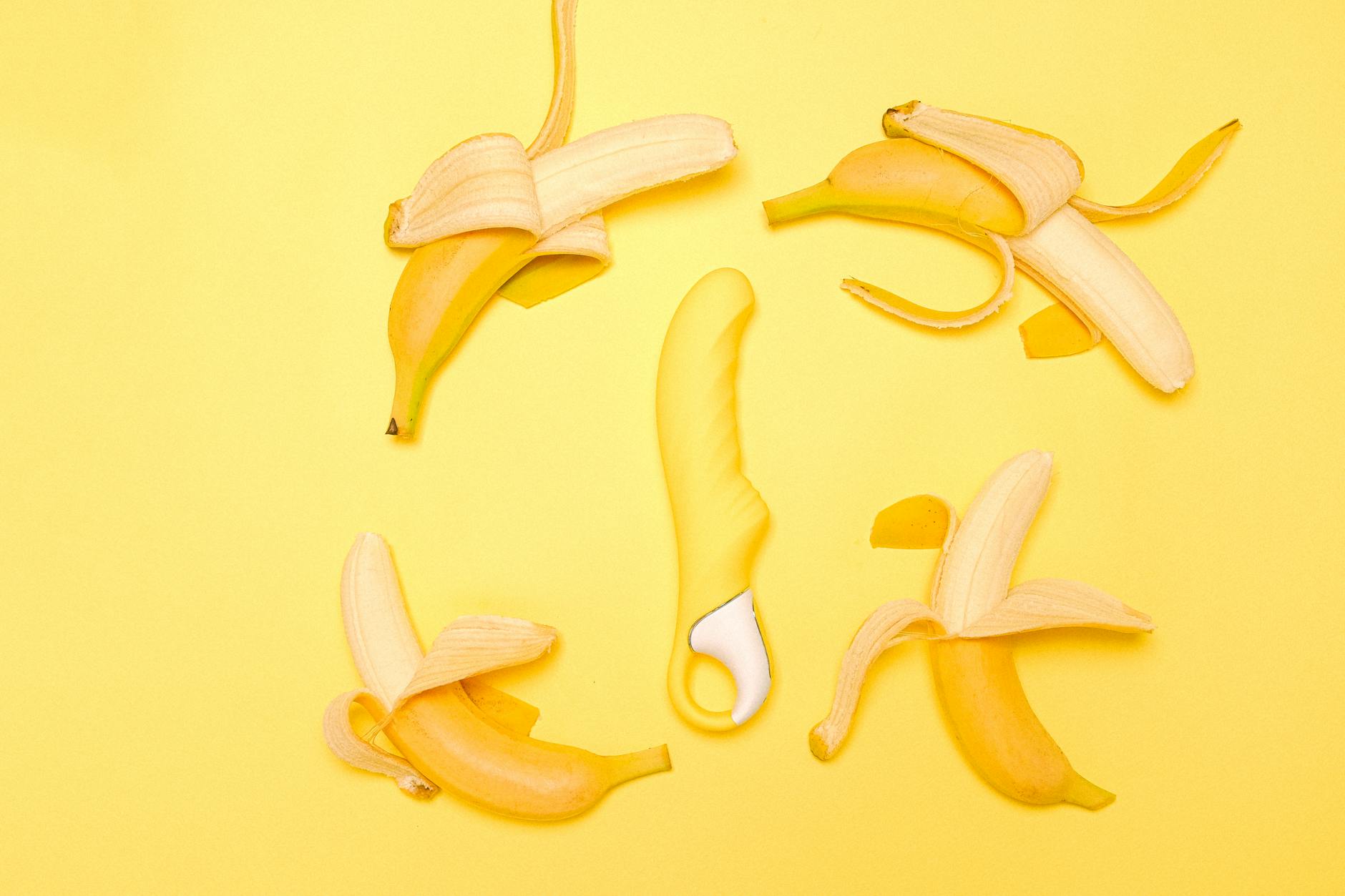 A hand holding a fresh lemon against a vivid yellow background, symbolizing renewed sensation and arousal.