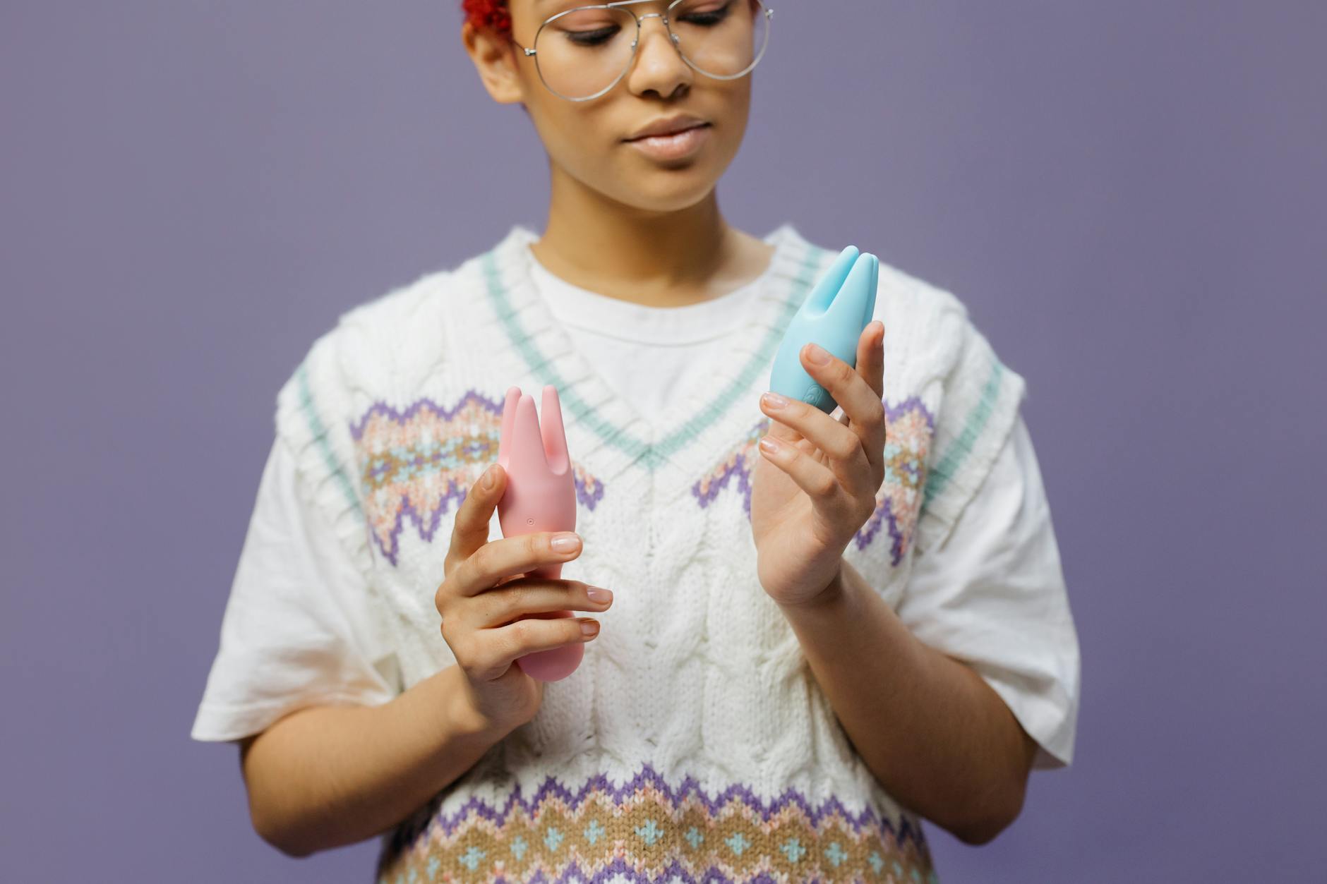 Woman holding a blue silicone vibrator, ready to explore new sensations with lubricant.